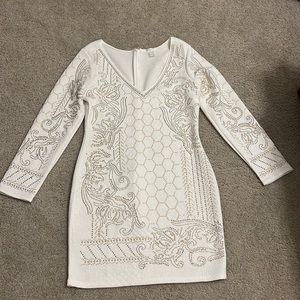 White dress with gold accents.